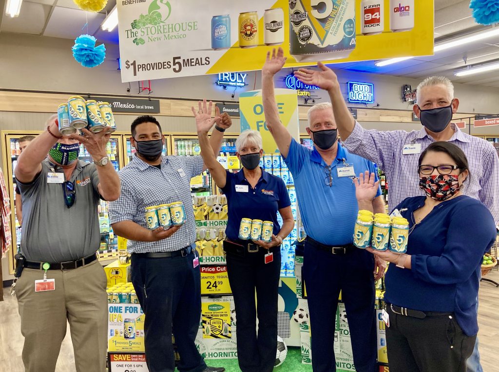 Albertsons Market managers and directors hold cans of One for 5 beer that they are selling as a fundraiser for the Storehouse.