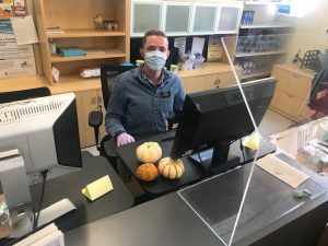 volunteer from LDS church helps at the front counter of the Storehouse food pantry