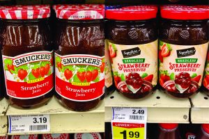 Smuckers strawberry jelly is shown next to store brand jelly to show the cost savings of store versus national name brands. 