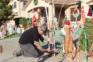 Jared sets up lights in front of his house.