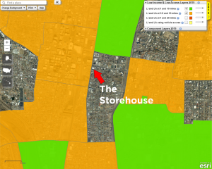 A partial map of Albuquerque. In the middle is an arrow pointing to a building with the text "the Storehouse" below it. The area that the Storehouse is in is completely surrounded by marked food deserts.