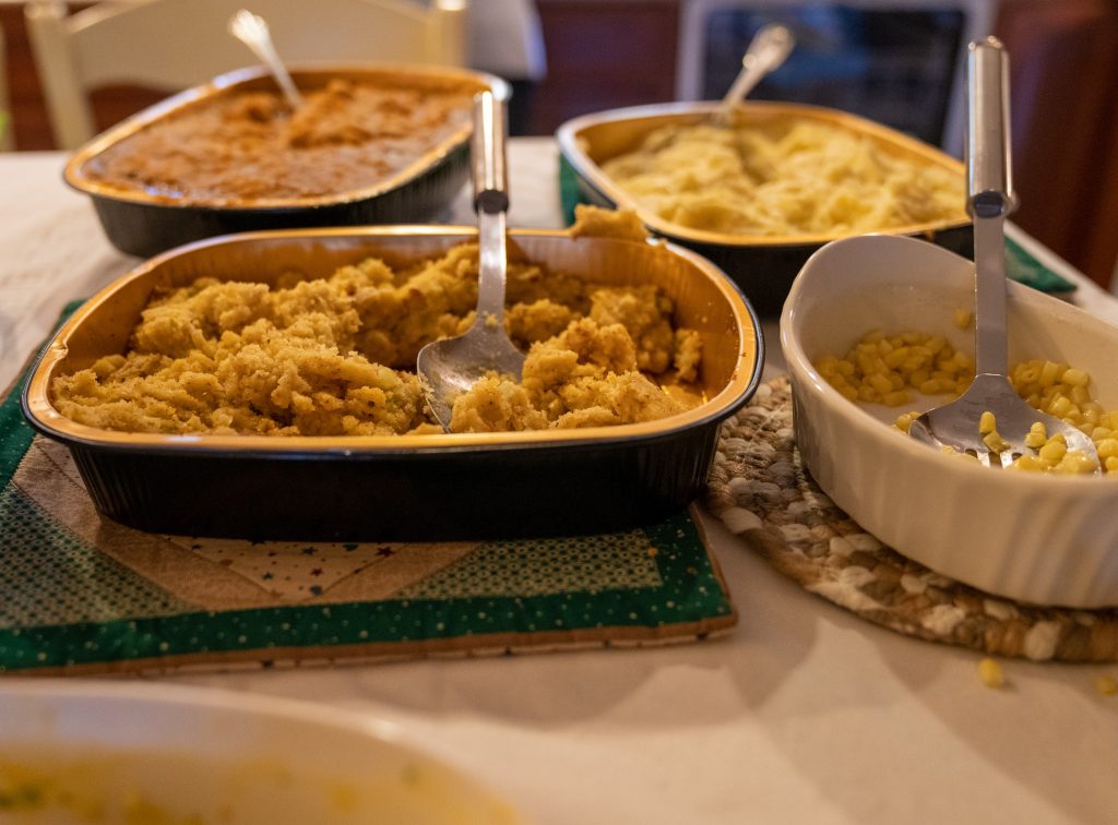 left over food in containers on a dining table. 