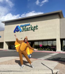 Man in Thanksgiving turkey costume in front of Albertsons Market grocery story