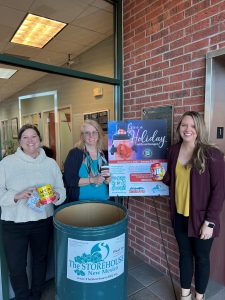Sandia area team members put food into a Storehouse New Mexico food collection bin