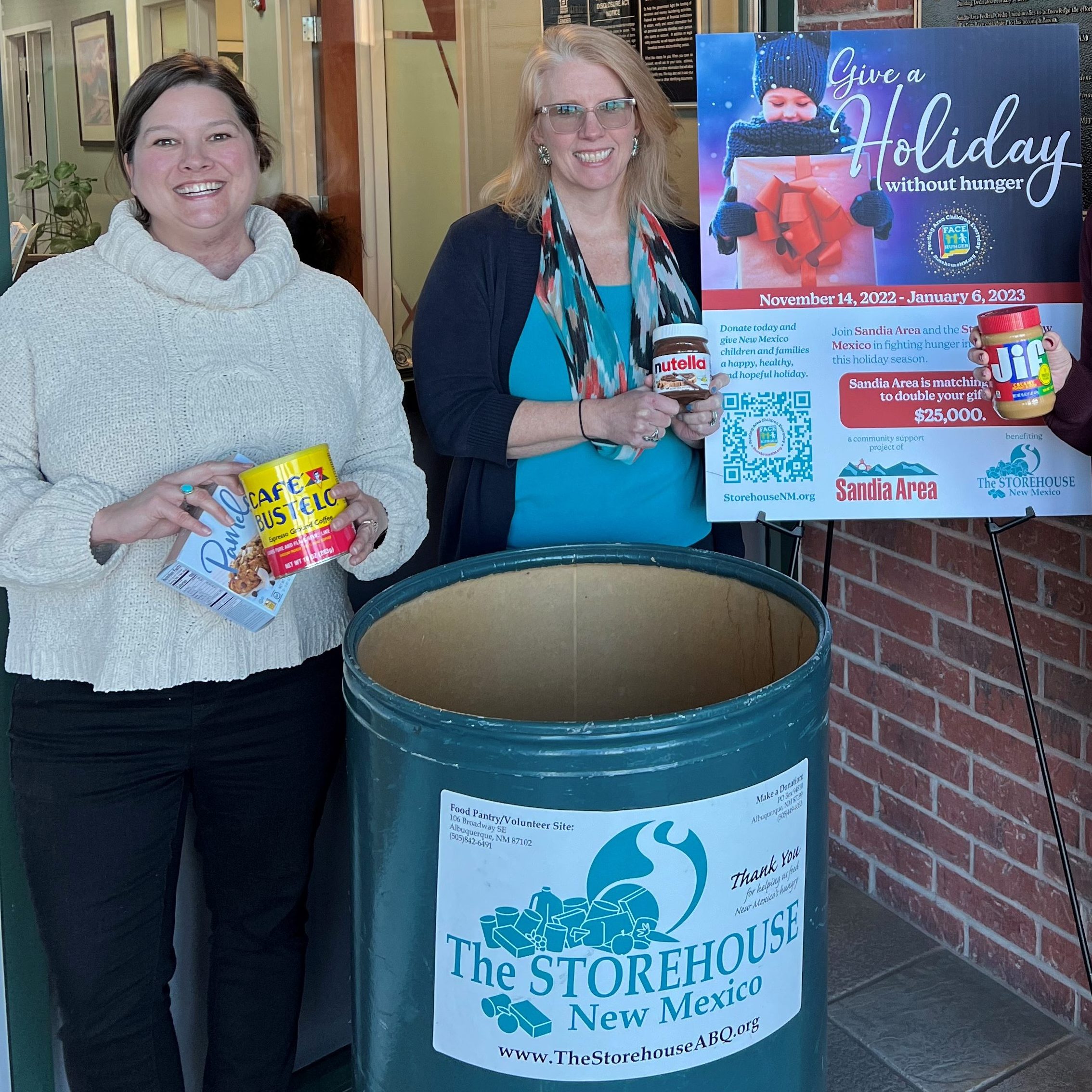 Sandia Area team members putting canned goods and shelf stable foods into a Storehouse New Mexico collection bin. 
