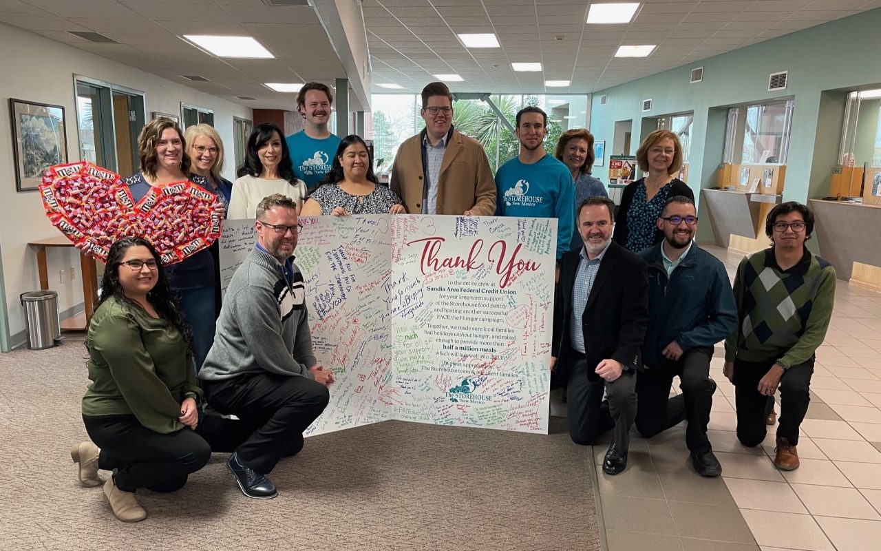 The Storehouse team is pictured with staff members of Sandia Area Federal Credit Union. The food pantry delivered a giant card expressing their appreciation to Sandia Area for the most recent FACE the Hunger campaign. Clients, volunteers, and staff signed this huge thank you. Together we provided holidays without hunger!