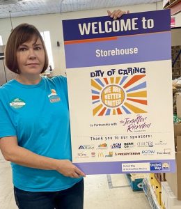 Day of Caring volunteer holds a United Way sign